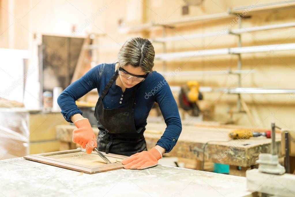 female carpenter working in woodshop