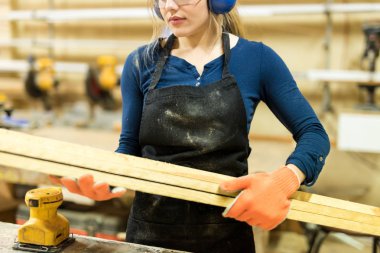 Female carpenter in workshop clipart