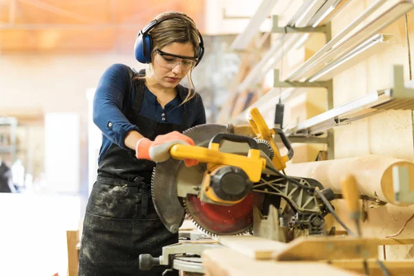 Mujer usando herramientas eléctricas en carpintería — Foto de Stock