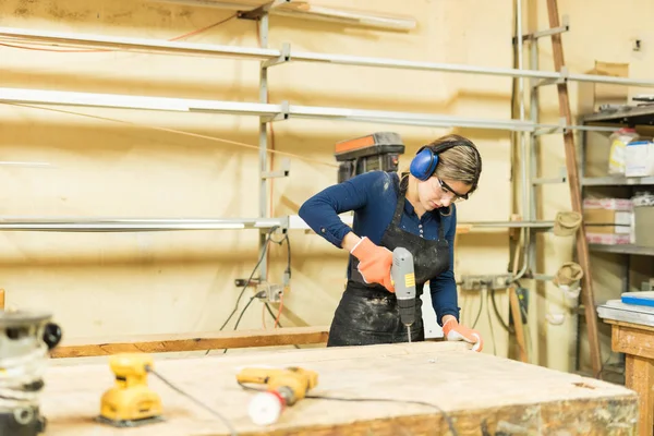 Young woman using screwdriver at work — Stock Photo, Image