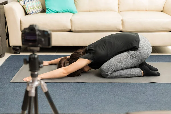 Woman practicing yoga on video