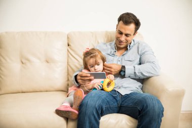 Father and daughter listening music  clipart