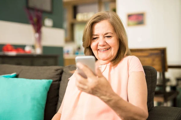 Latin grandmother using smartphone