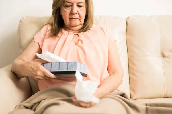 Aged lady holding tissue — Stock Photo, Image