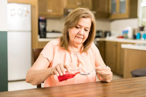 Lady taking spoon of sore — Stock Photo, Image