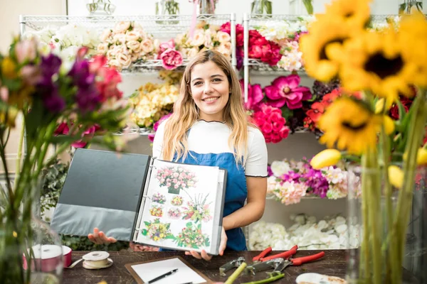 Floristry specialist showing her catalogue