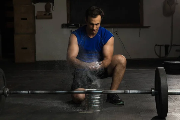 Young man using gym chalk — Stock Photo, Image