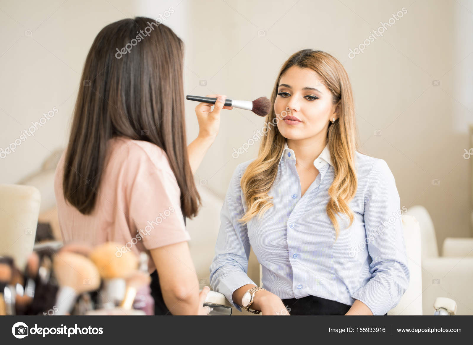Makeup artist at work in salon Stock Photo by ©tonodiaz 155933916