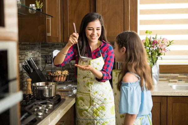 Mère offrant de la soupe à sa fille — Photo