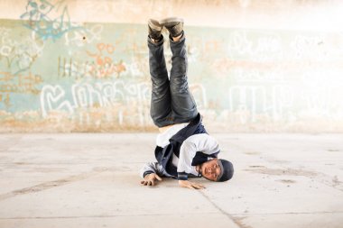 Male dancer doing a headstand clipart