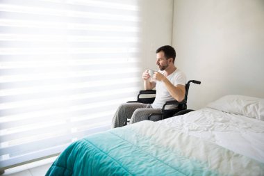 Adam biraz kahve içme tekerlekli sandalye üzerinde