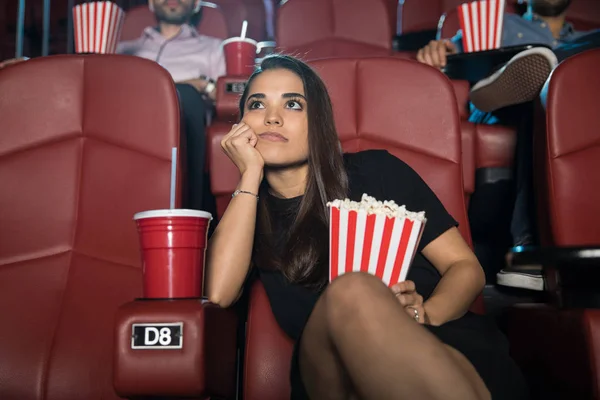 Bored woman in cinema — Stock Photo, Image