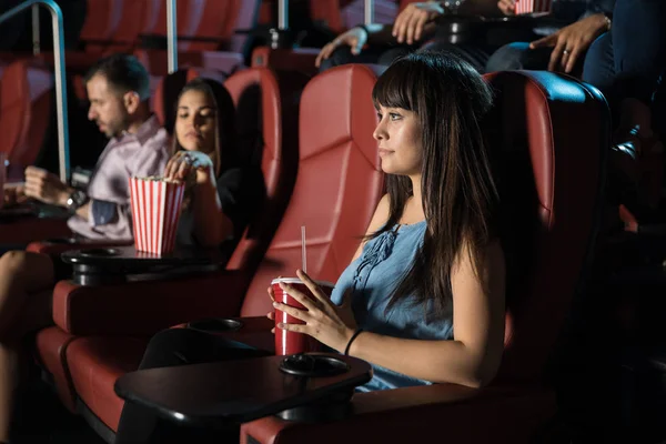 Young woman watching movie at cinema — Stock Photo, Image