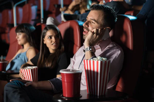 Man talking on phone at cinema — Stock Photo, Image