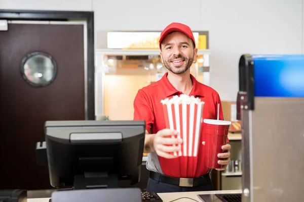 Movie theatre worker holding snacks — Stock Photo, Image