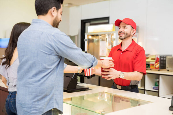 Young couple getting popcorn and soda
