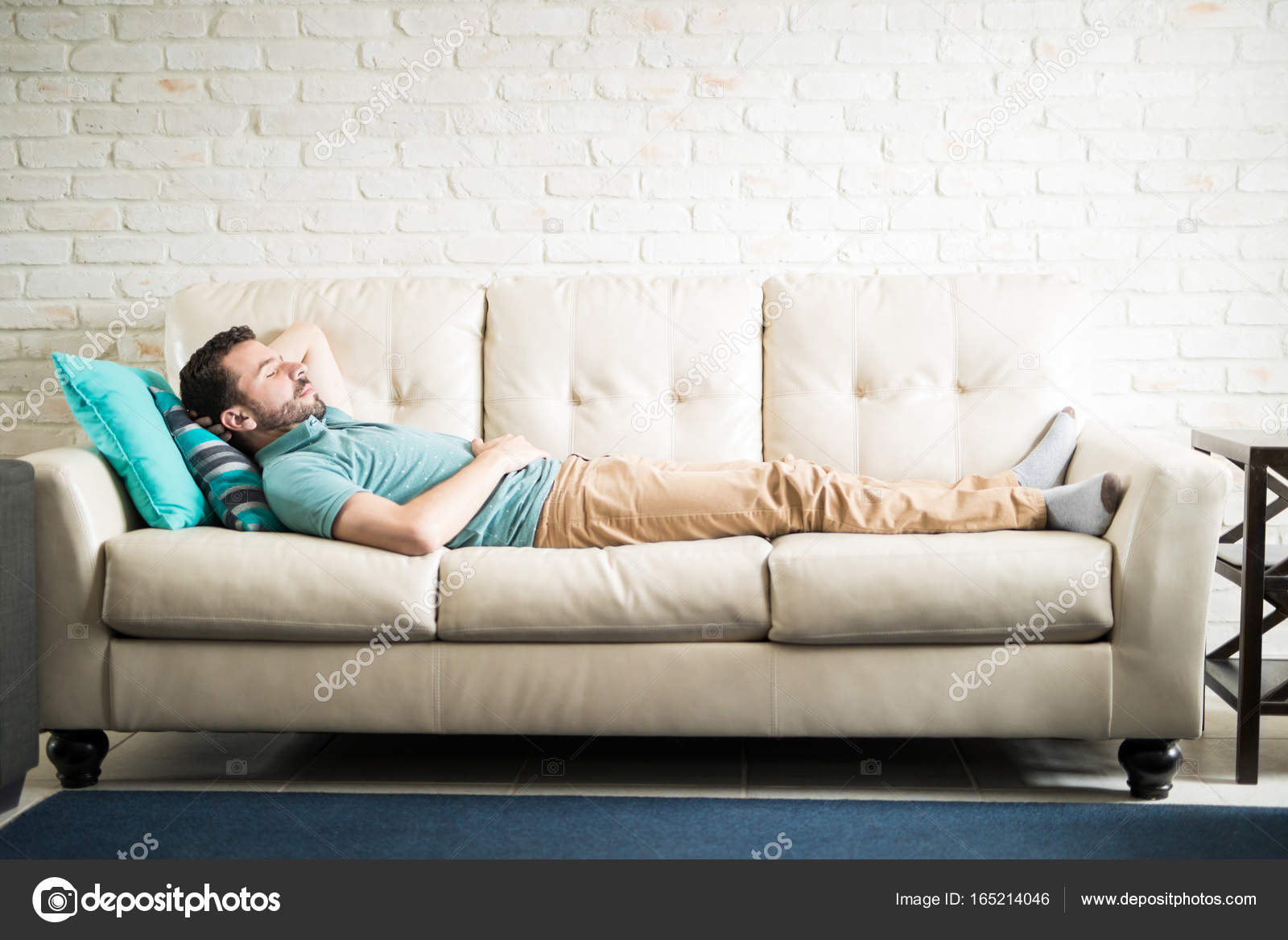 Man Lying Down In Cozy Sofa Stock Photo Tonodiaz