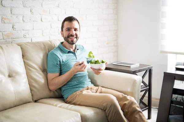 Mannen äter frisk och grön sallad — Stockfoto