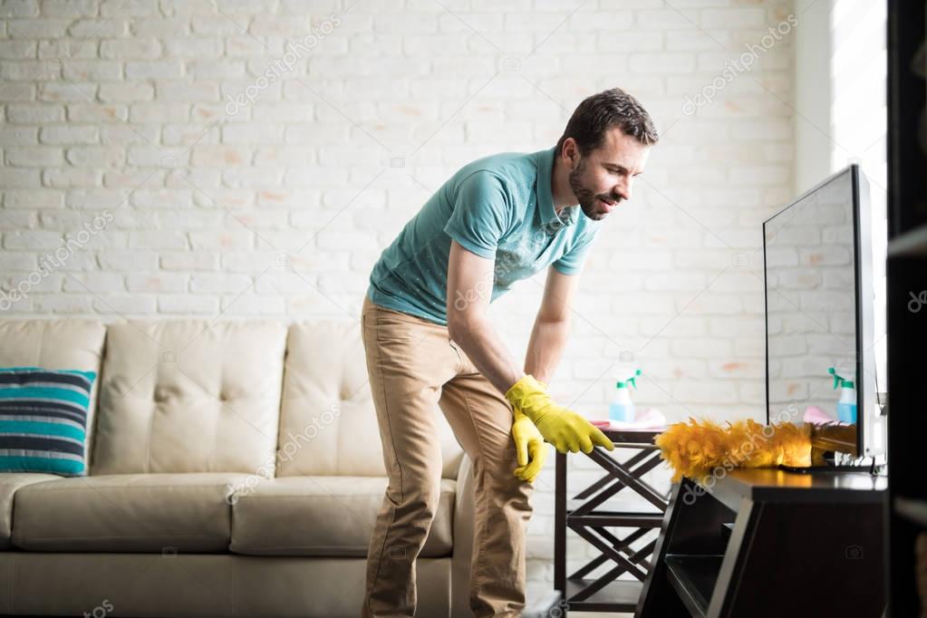 man keeping house clean