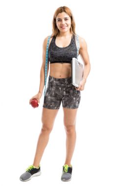 bir ölçek ve bir elma tutan kadın 