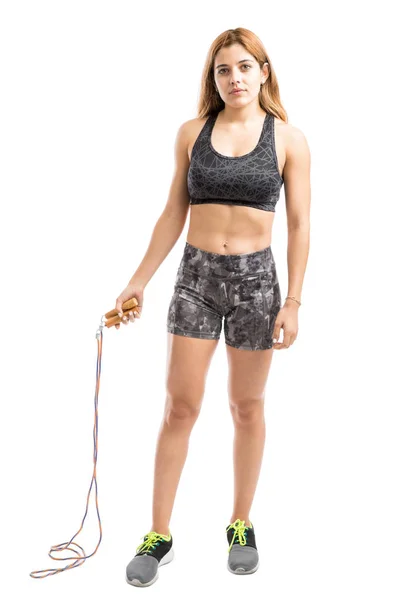 Woman with abs holding a jump rope — Stock Photo, Image