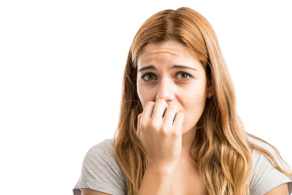 Young woman biting nails — Stock Photo, Image