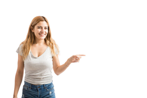 Woman pointing towards copy space