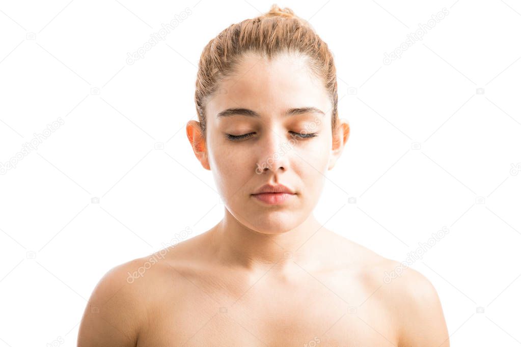 woman with bare shoulders and eyes closed