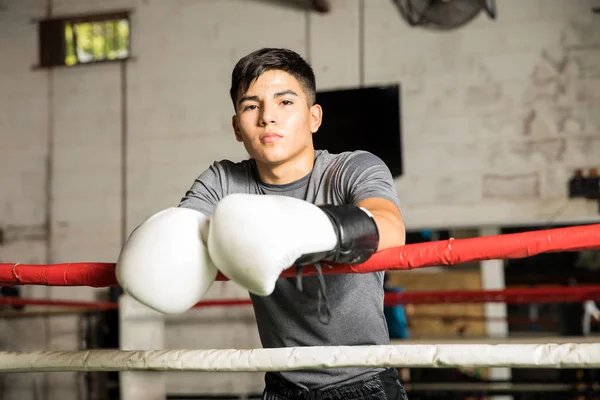 Male boxer leaning on the ropes — Stock Photo, Image