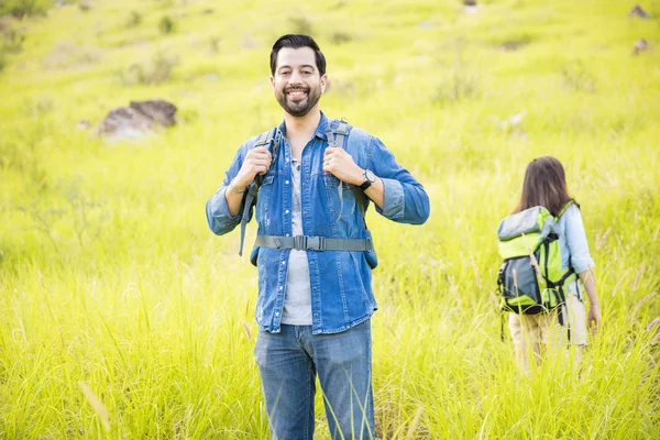Excited man hiking with his girlfriend — Stock Photo, Image