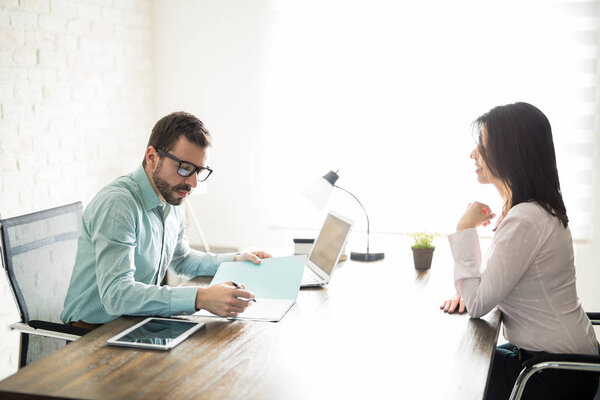 Man reading the resume of a woman