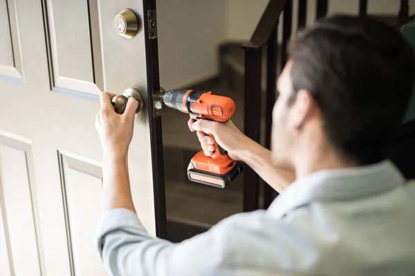 Pov of a handyman fixing door ruck — стоковое фото
