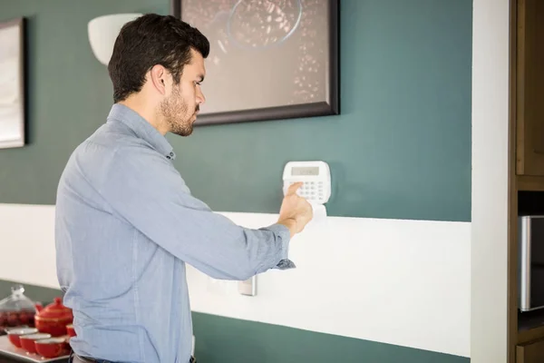 Man activating a home alarm — Stock Photo, Image