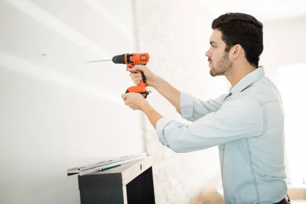 Man using power drill on a wall — Stock Photo, Image