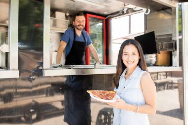 Woman buying pizza from a food truck clipart