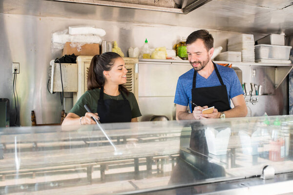 Two people working in food truck