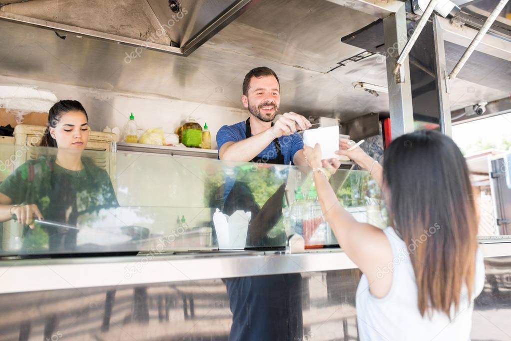 Man serving food to customer