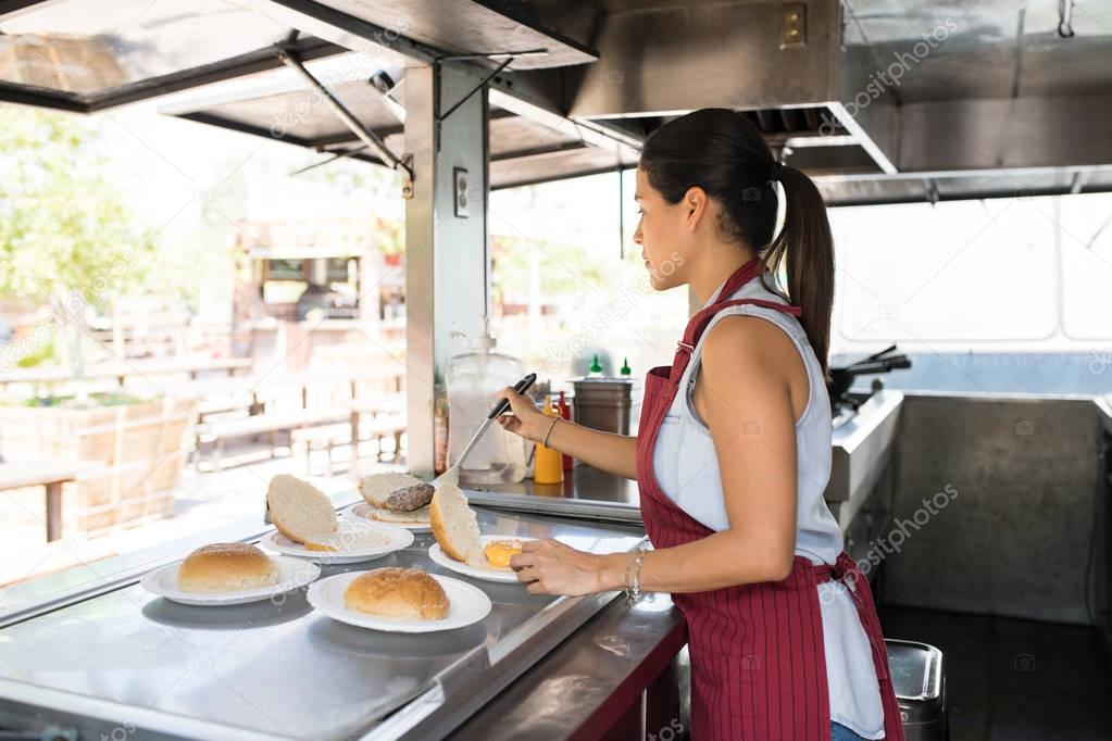 Cook in food truck making burgers