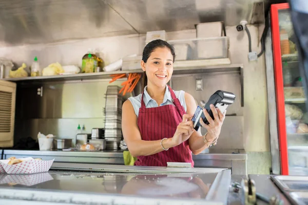 Food truck owner with credit card terminal — Stock Photo, Image