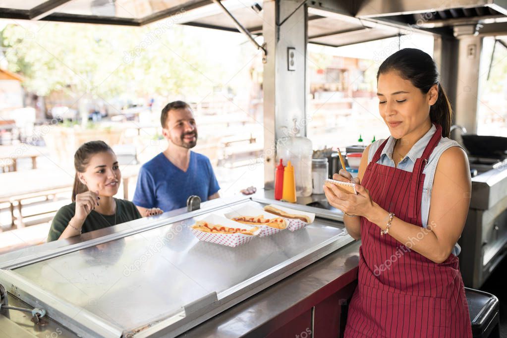 Woman taking orders in a food truck