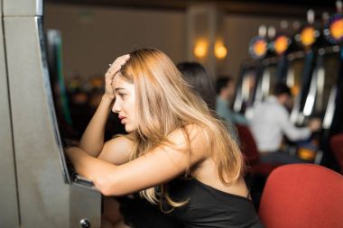 Bir casino slot makinesidir tüm parasını kaybettikten sonra üzgün ve stresli arayan şanssız kadın