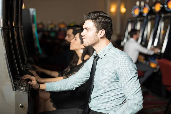 Profile View Young Man Passing Time Playing Slot Machine Casino — Stock Photo, Image