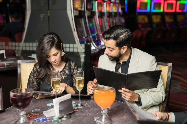 Young Couple Sitting Casino Restaurant Looking Menu Ordering Some Food — Stock Photo, Image