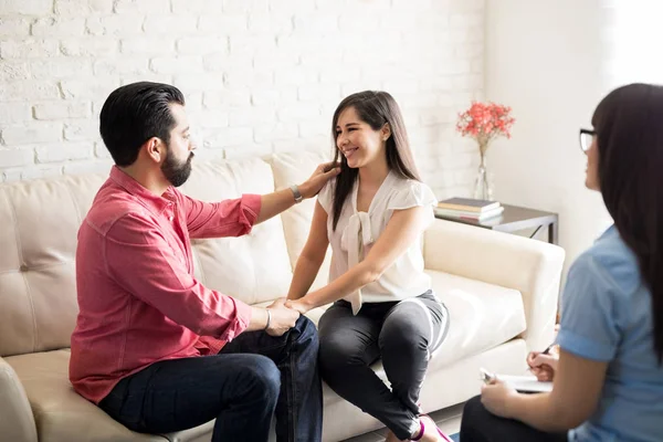 Happy couple sitting on sofa — Stock Photo, Image