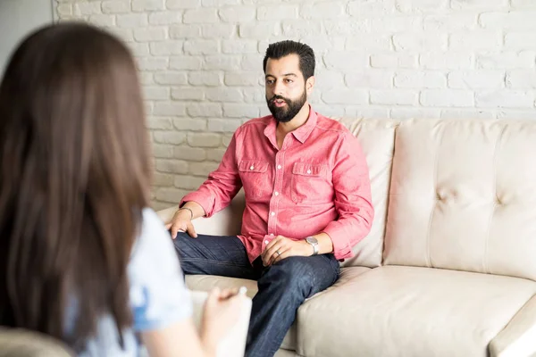 Man sharing problems with psychologist