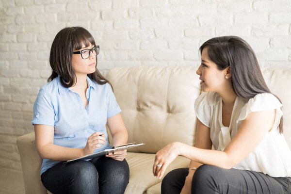 Psychologist talking to female patient
