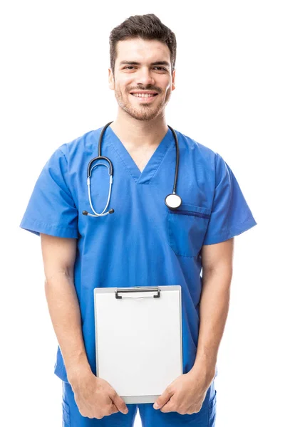 Young doctor holding blank clipboard — Stock Photo, Image