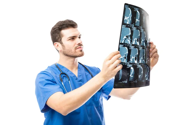 Young doctor examining x-rays — Stock Photo, Image