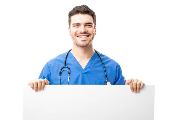 Young male doctor holding banner — Stock Photo, Image