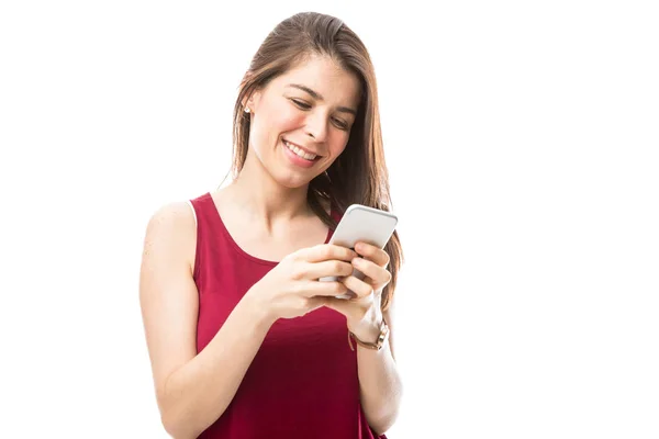 Young woman checking on smartphone — Stock Photo, Image